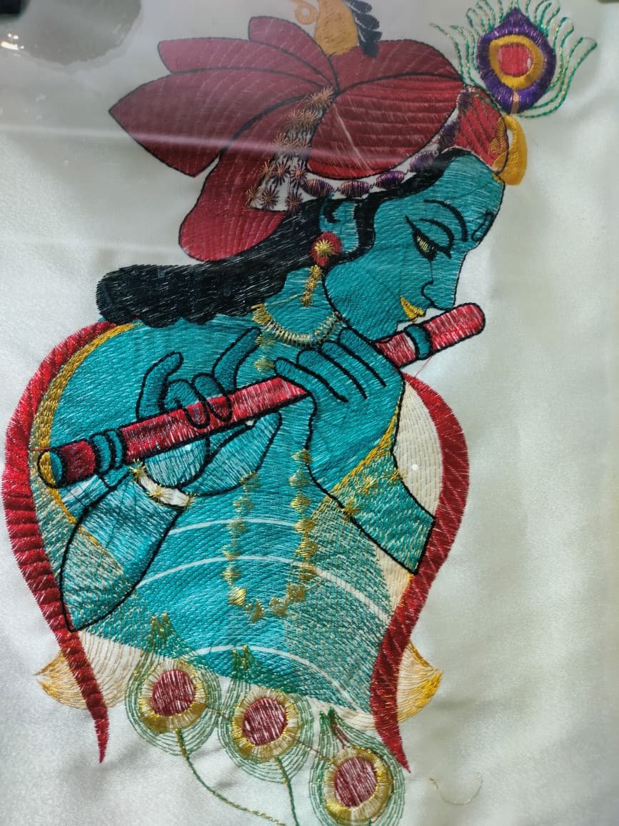 Krishna motif thread embroidery in teal and red