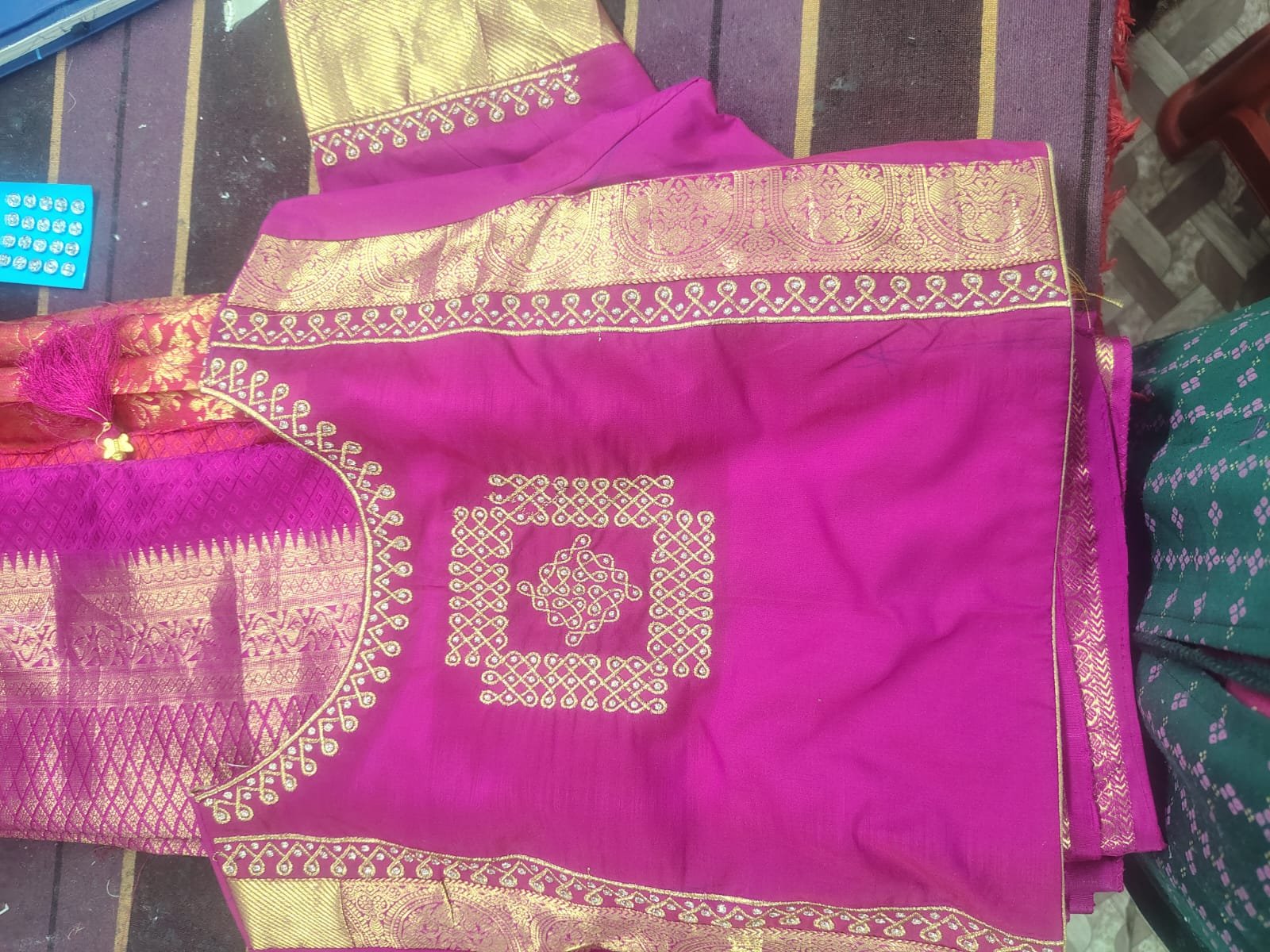 Kasuti style gold embroidery on magenta pattu saree