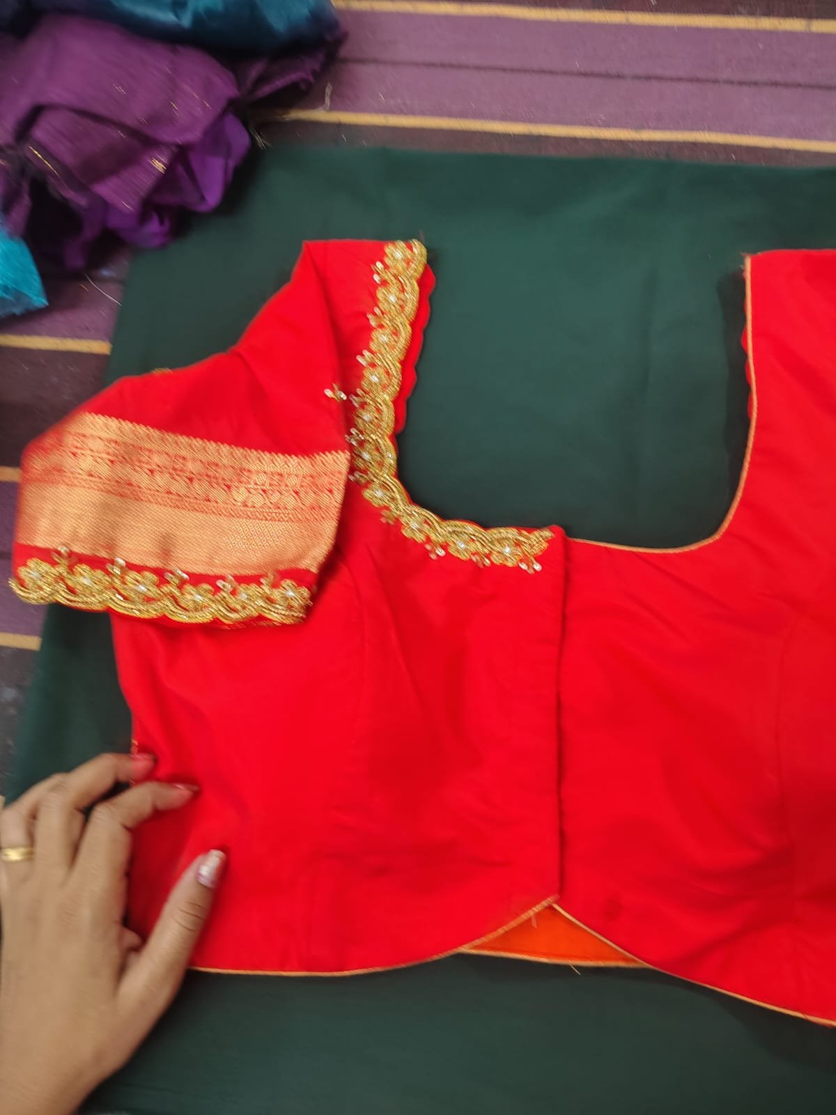Finished red bridal blouse with pearl trim