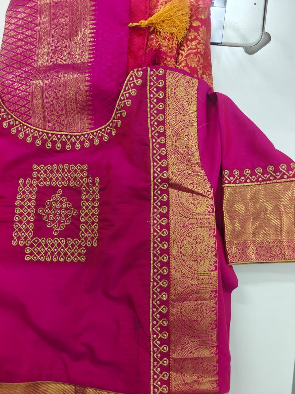 Magenta silk saree with gold zari border and mirror work blouse